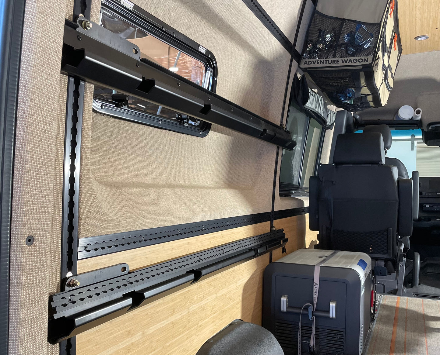 Rails for adjustable camper van bed shown.