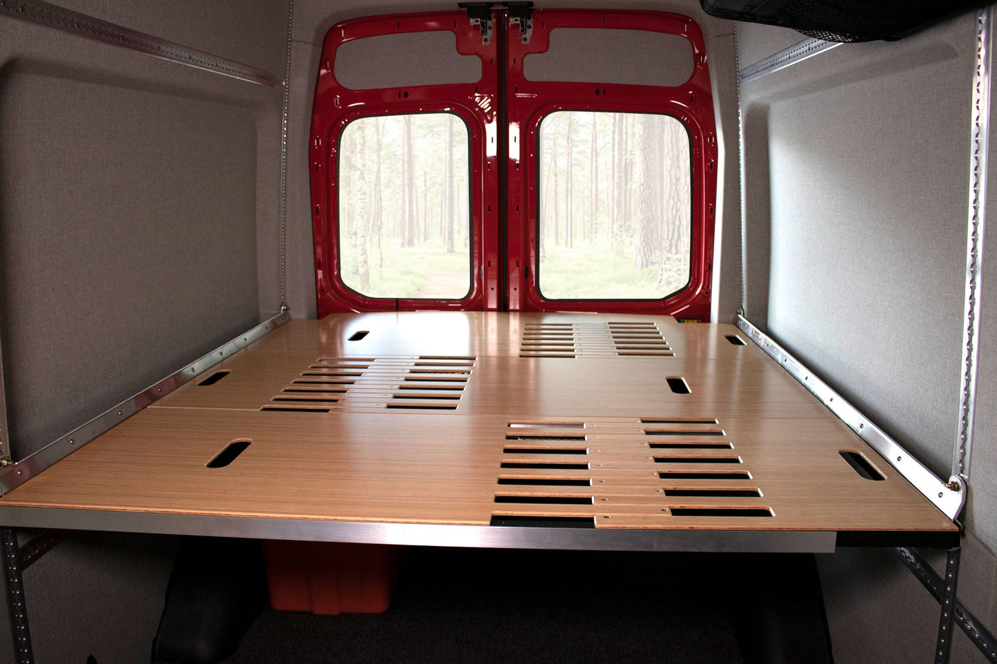 Adjustable van bed system shown in camper van