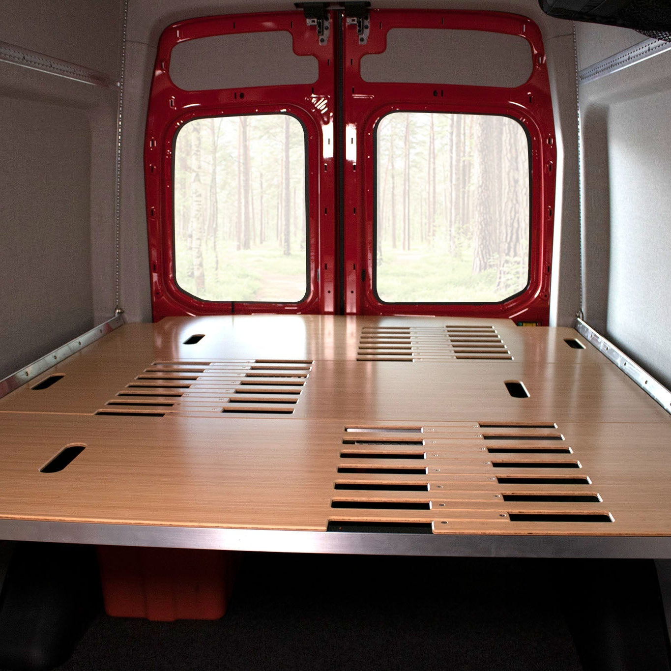 Adjustable van bed system shown in camper van