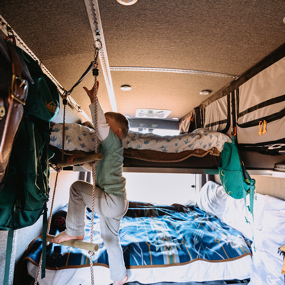 Inside of van, kids climbing onto MOAB Traverse Camper Van Bed