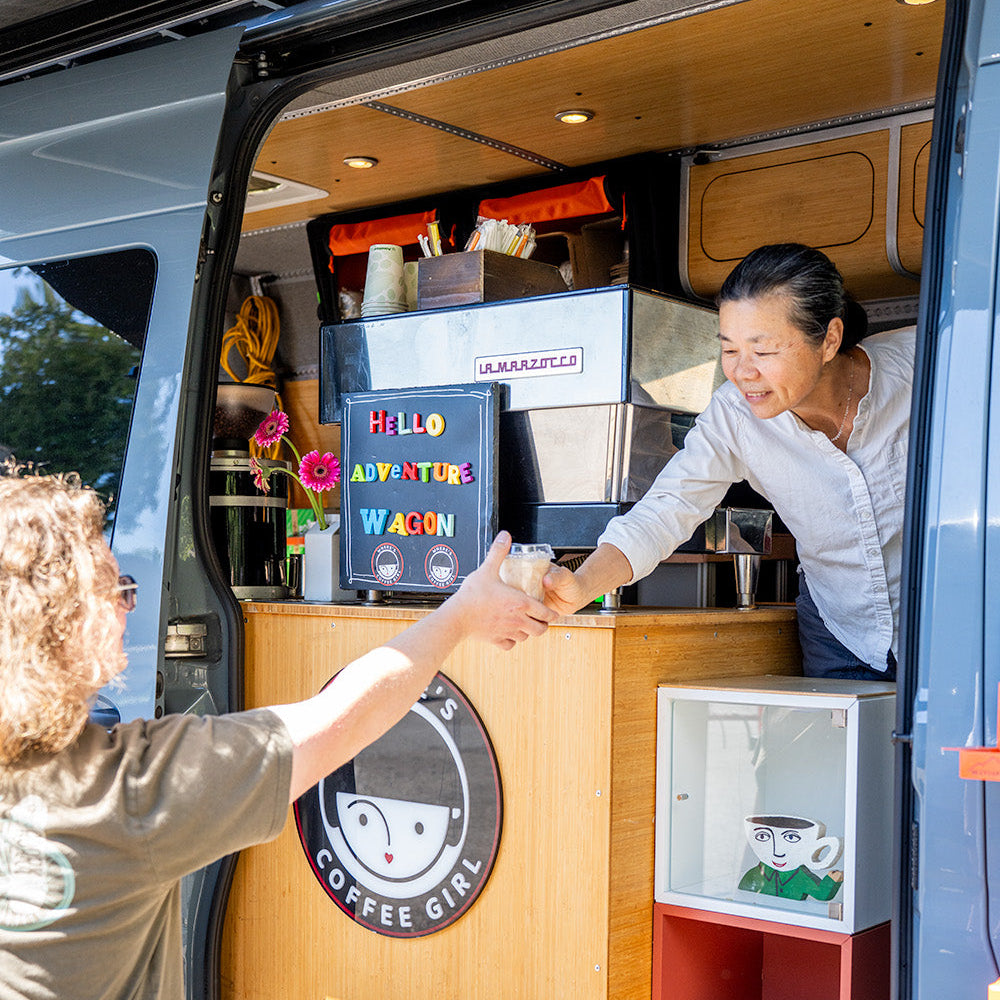 A Commercial Coffee Van Owner Serving Coffee