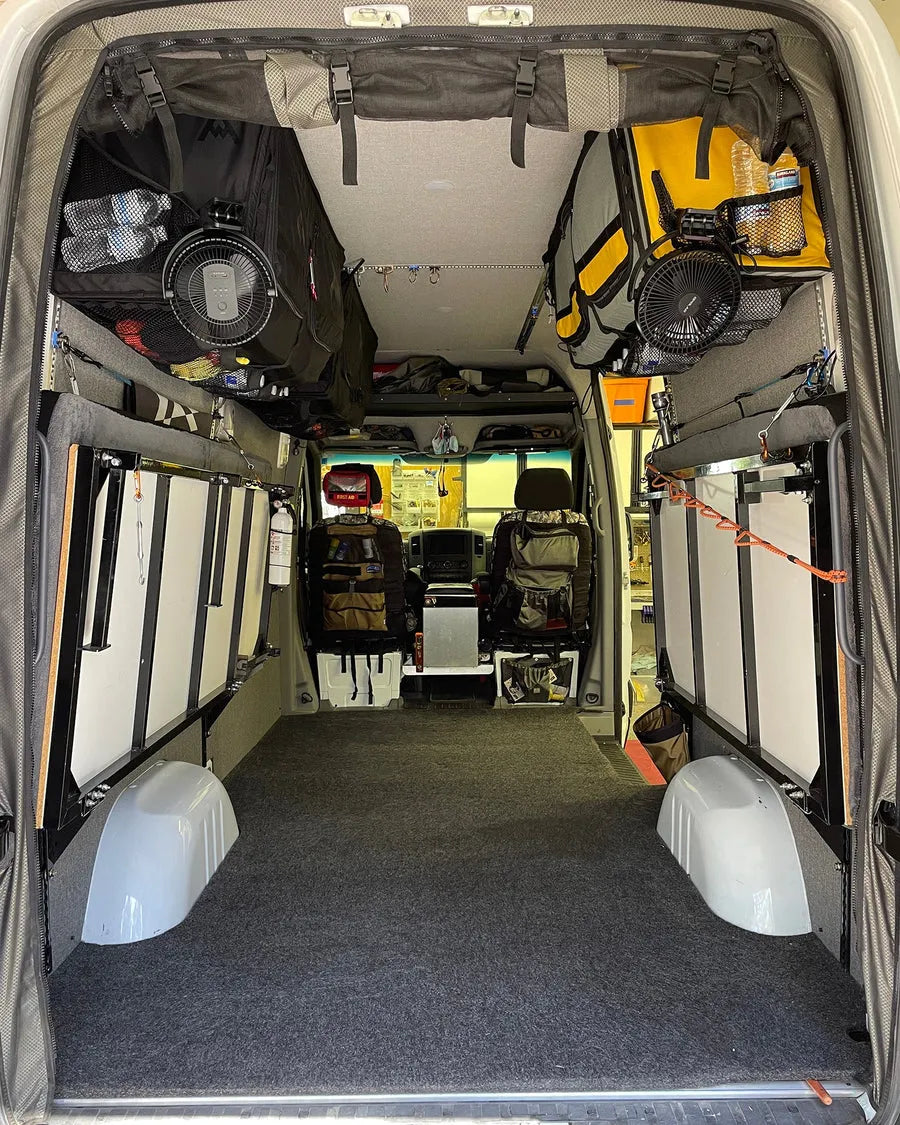 Adventure Wagon camper van gear hauler interior with modular storage, bed platform, bike and gear carrying space.