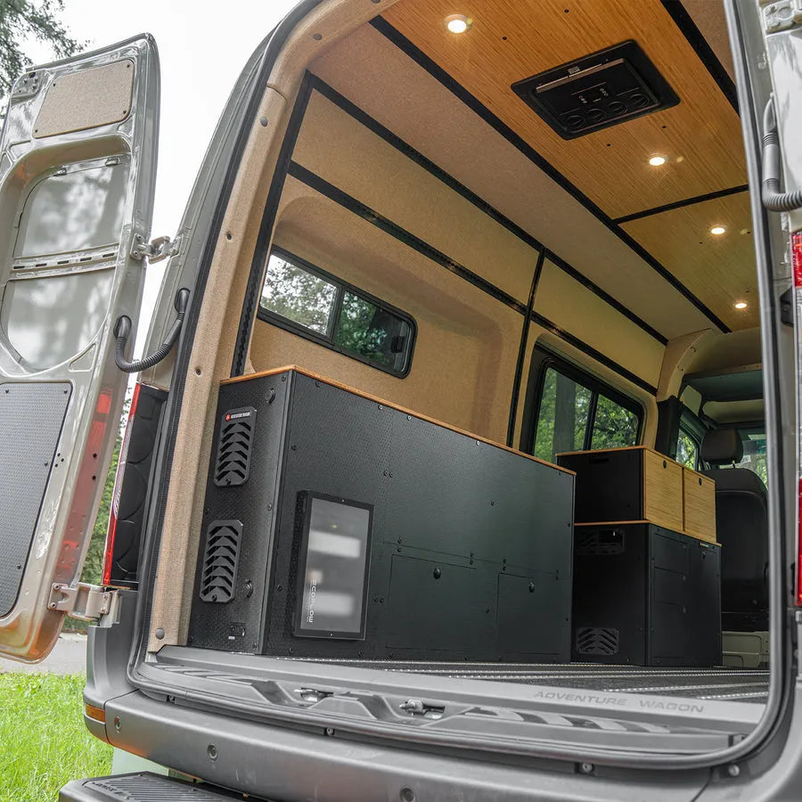 Adventure Wagon camper van electrical system and Switchback Galley integrated into the rear interior storage cabinetry.