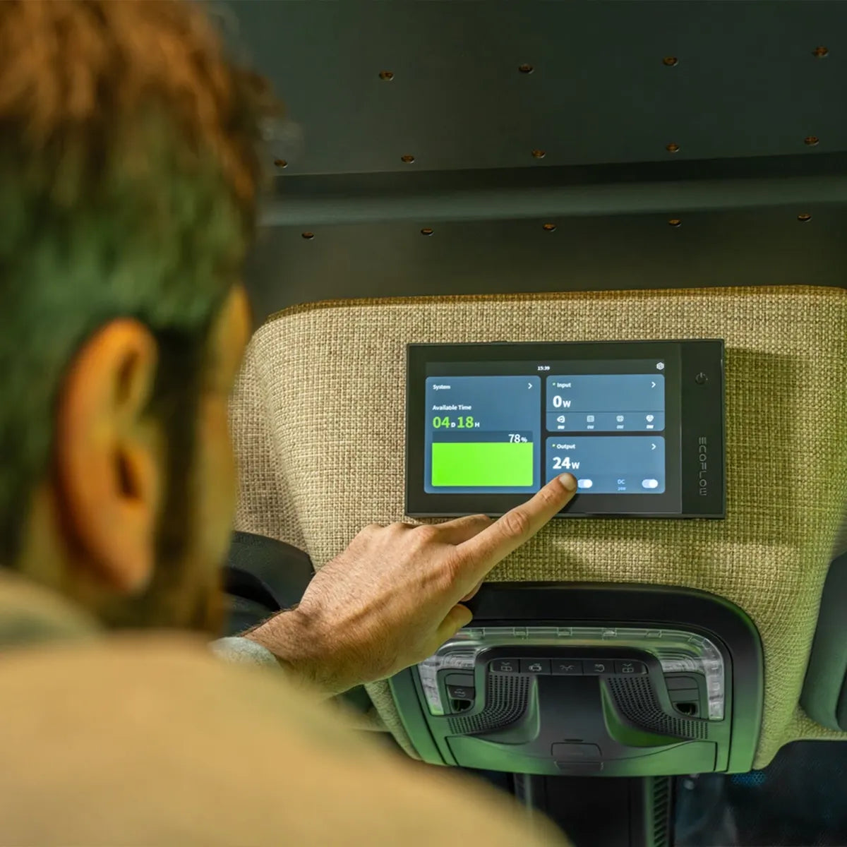 Adventure Wagon camper van electrical system touchscreen control panel displaying battery level, power input and electrical output information.