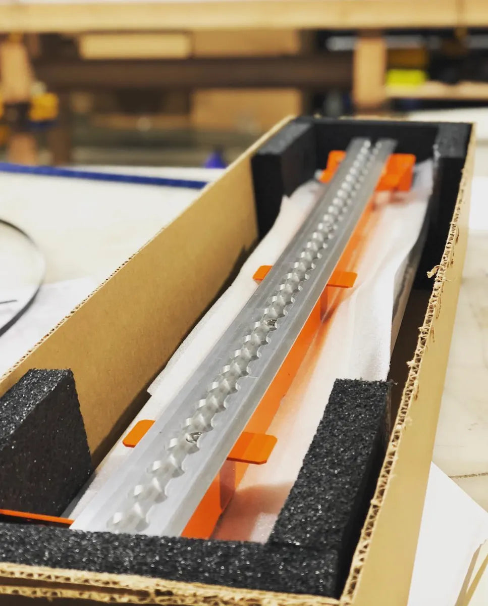 Adventure Wagon Factory Install showing L-Track rails in box.