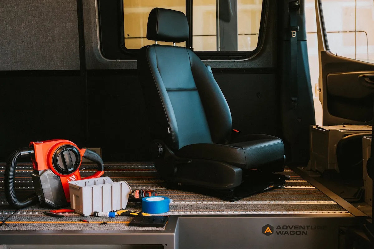 Adventure Wagon camper van passenger seat mounted to the integrated floor track during the Factory Install process.