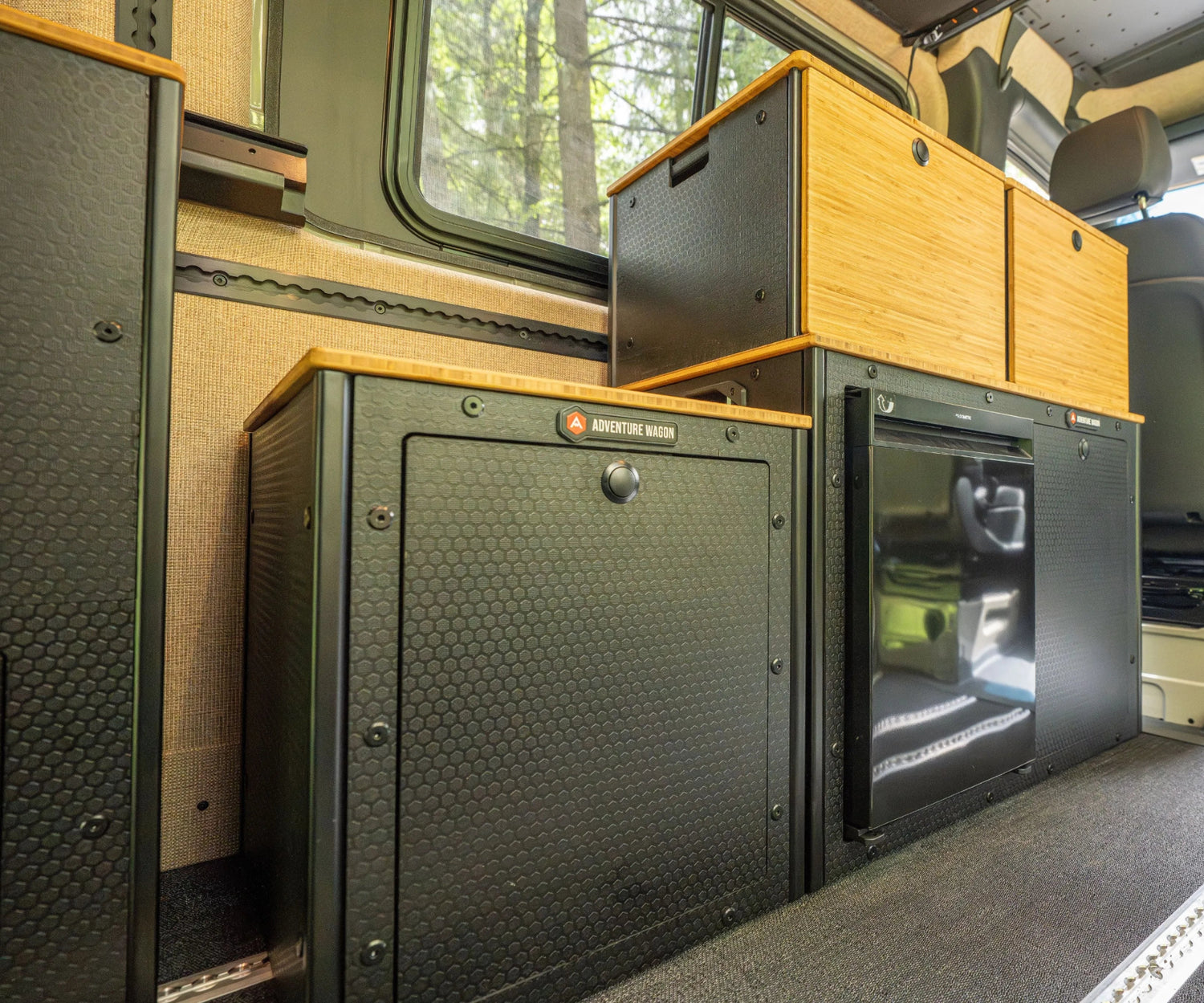 Adventure Wagon Guided Build 538 Switchback Galley with bamboo cabinetry, refrigerator, and modular camper van storage.