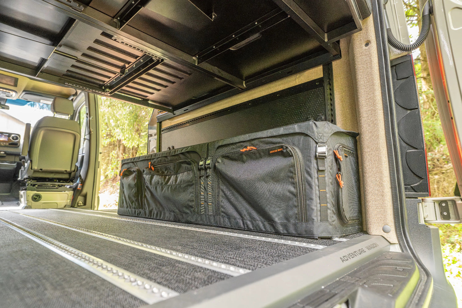 Adventure Wagon Guided Build 538 rear cargo area with modular bed platform and organized under-bed camper van storage.