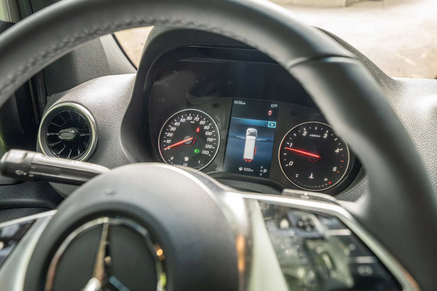 Adventure Wagon Guided Build 538 Mercedes Sprinter dashboard instrument cluster viewed through the steering wheel.