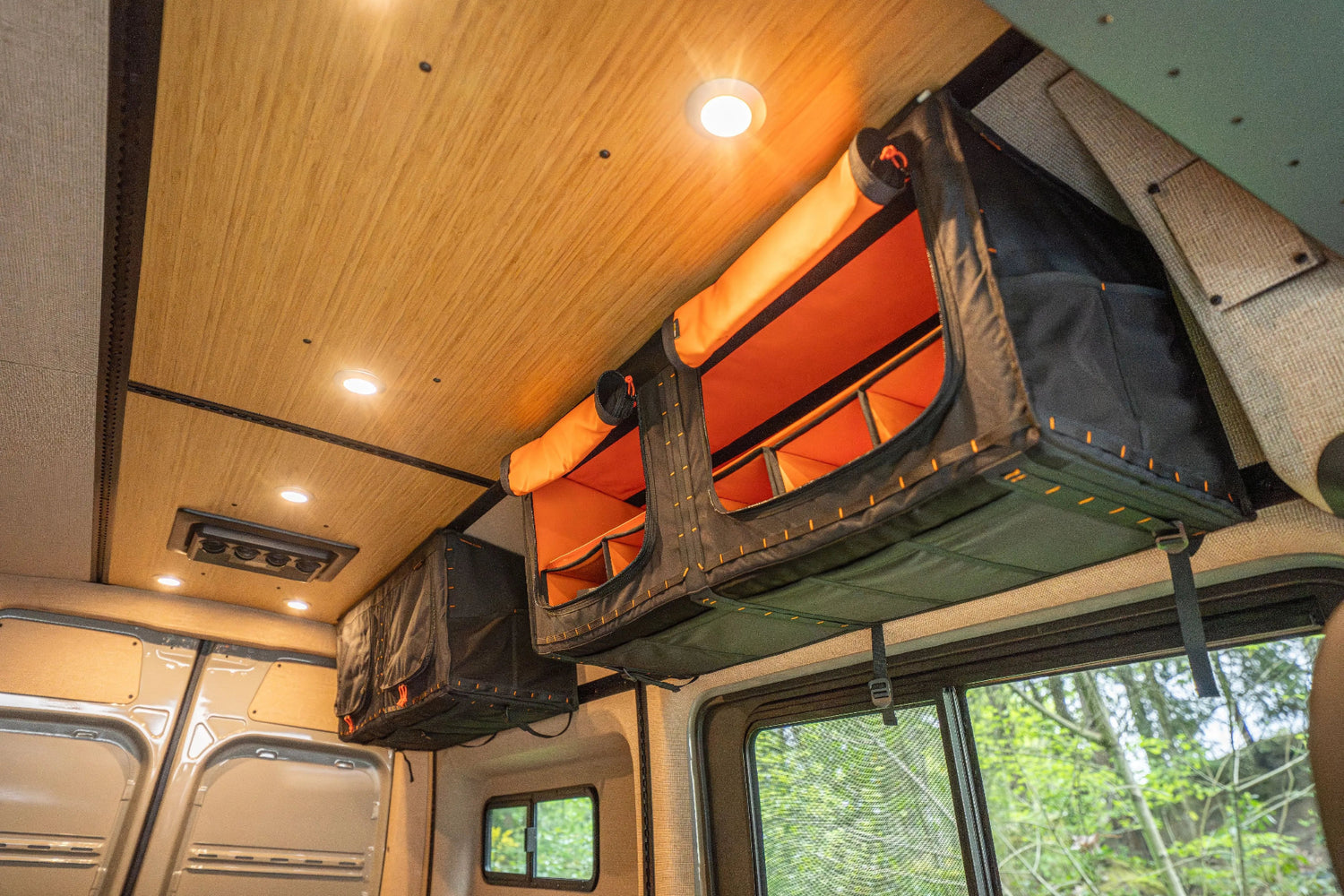 Adventure Wagon Guided Build 538 overhead Mule Bag storage mounted along the interior wall above the bed platform.