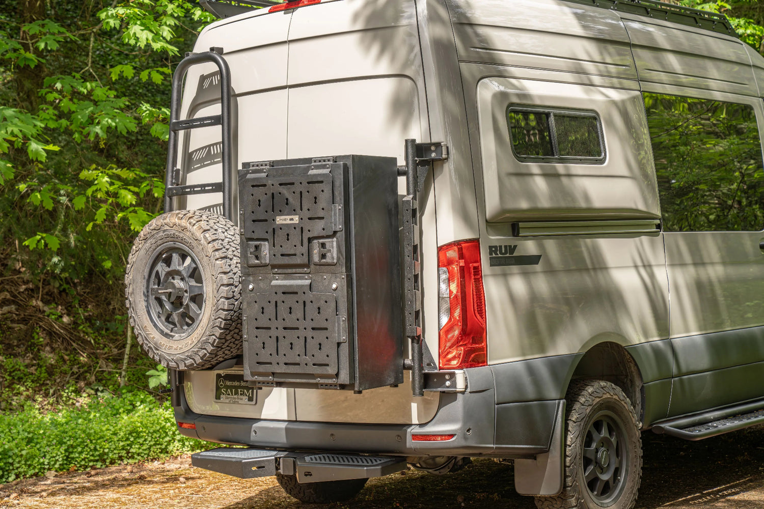 Adventure Wagon Guided Build 538 rear three-quarter exterior with spare tire, rear carrier, side flare, and RUV branding.
