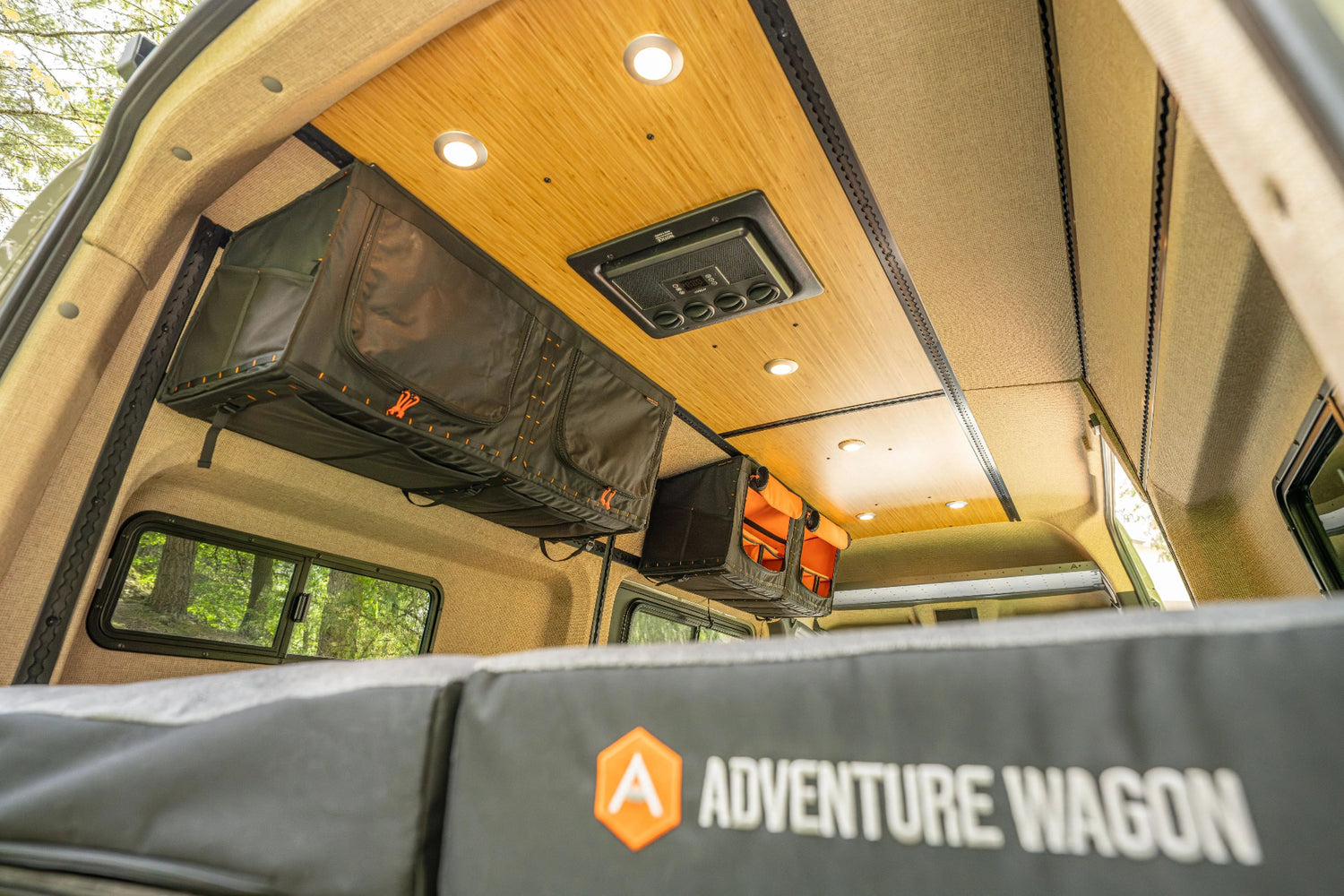 Adventure Wagon RUV 538 camper van interior with bamboo ceiling panels, integrated lighting, ventilation, and overhead Mule Bag storage.
