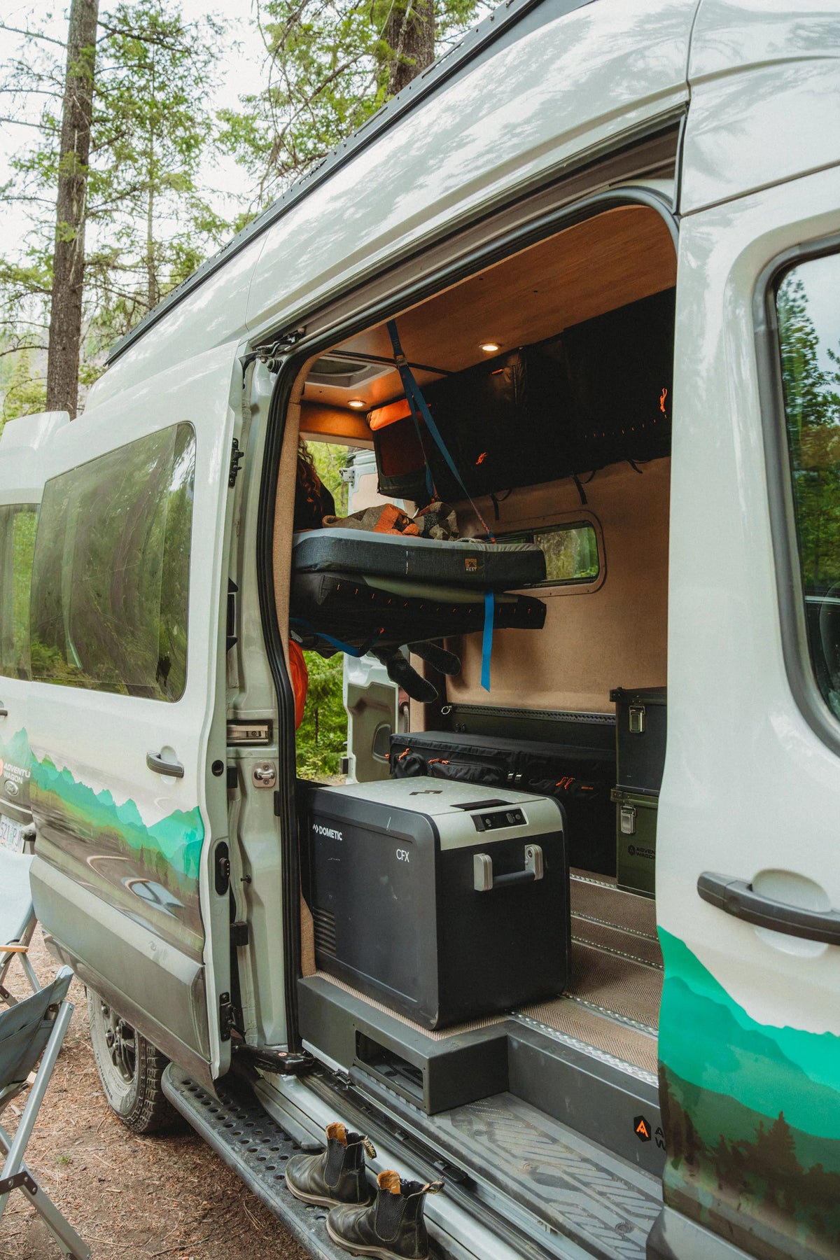Dometic CFX fridge positioned near the open side door of the Adventure Wagon Solo Nomad camper van.