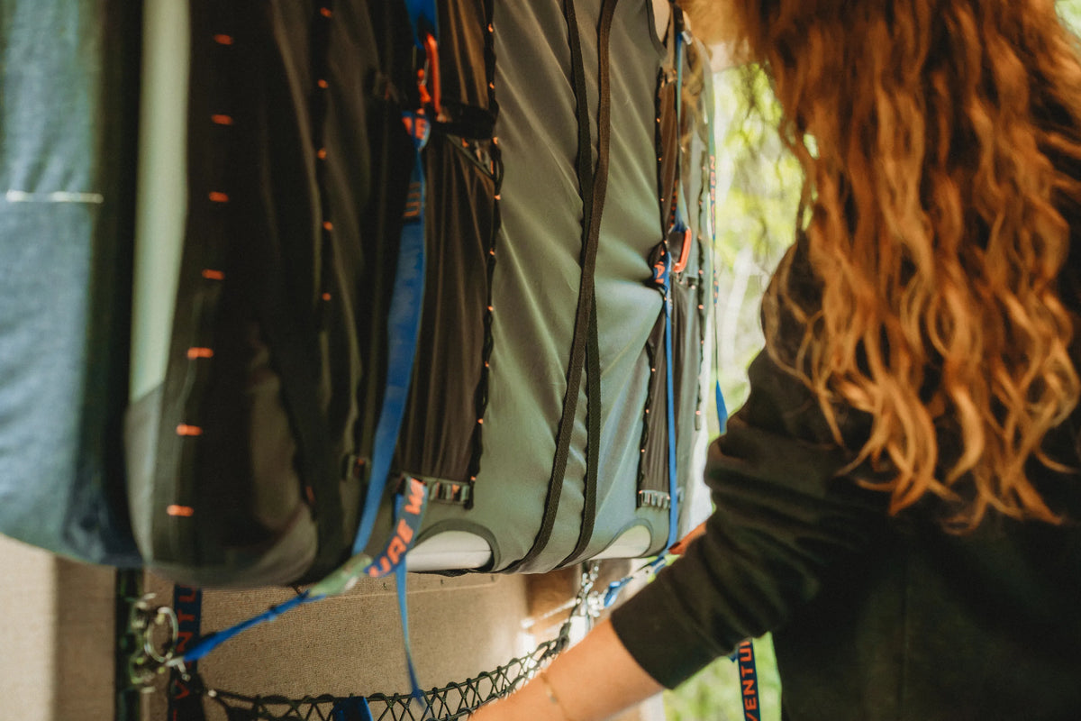 Close-up of the Soogan Bunk, mounting straps, and interior storage inside the Adventure Wagon Solo Nomad van.