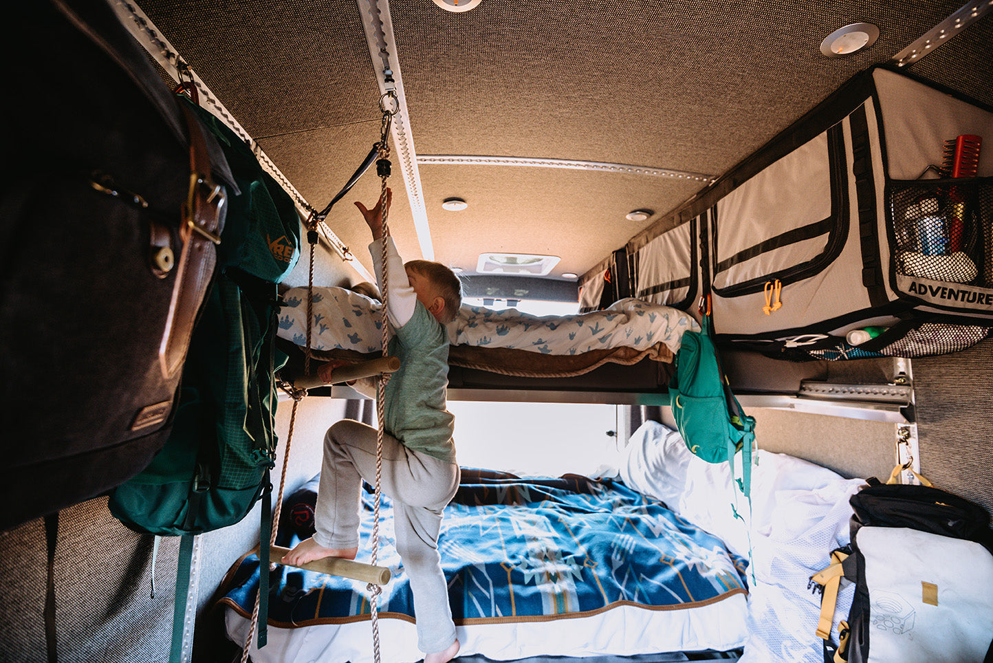 Inside of van, kids climbing onto MOAB Traverse Camper Van Bed